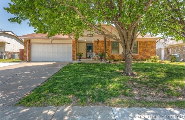 view of property hidden behind natural elements with stone siding, concrete driveway, a garage, a front yard, and stucco siding