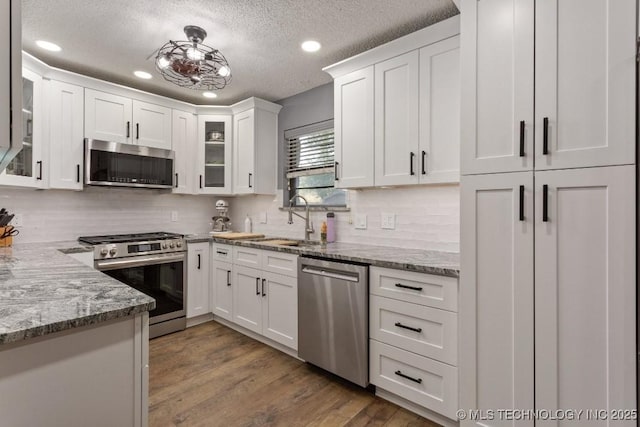 kitchen with recessed lighting, white cabinetry, stainless steel appliances, and a sink