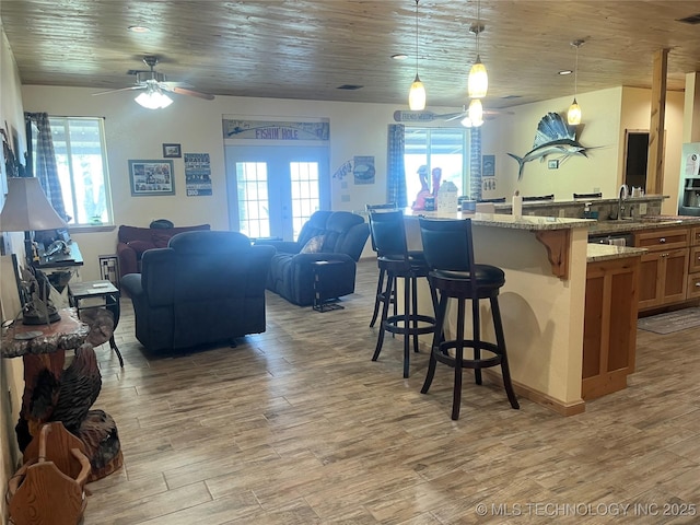 107349 S 4091st Rd, Checotah, OK 74426 - kitchen with open floor plan, plenty of natural light, a breakfast bar area, and ceiling fan