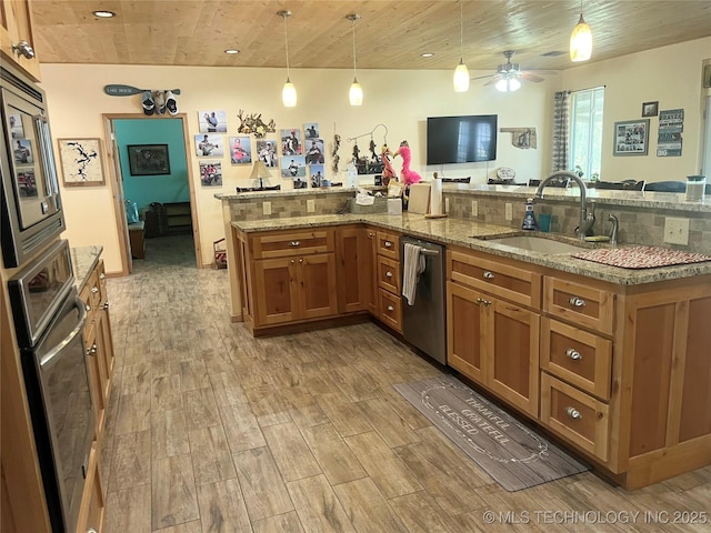 107349 S 4091st Rd, Checotah, OK 74426 - kitchen with brown cabinets, appliances with stainless steel finishes, wood finished floors, and a sink