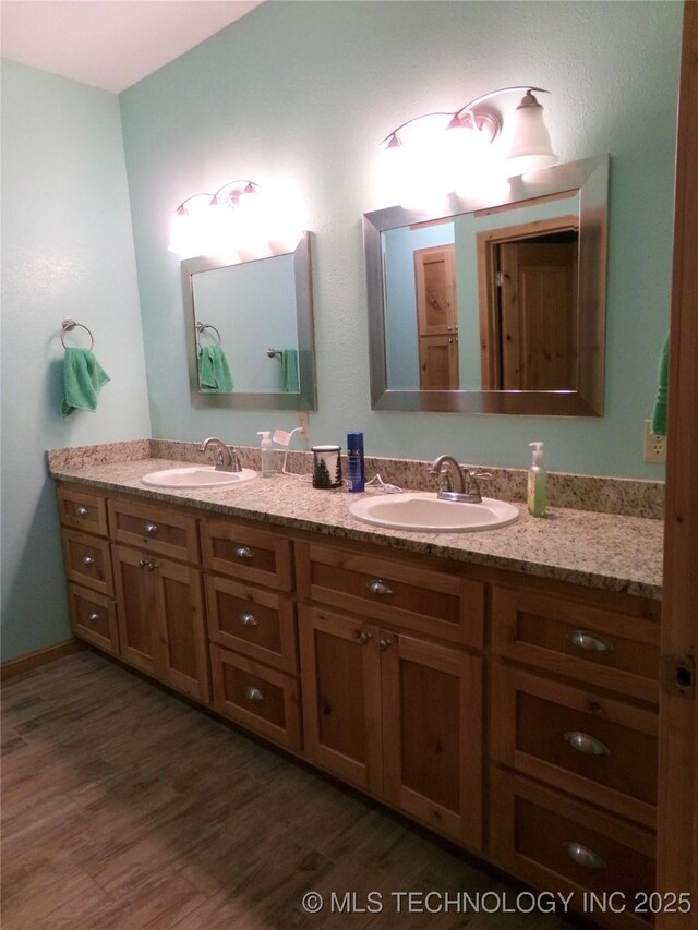 107349 S 4091st Rd, Checotah, OK 74426 - bathroom featuring wood finished floors, a sink, and double vanity