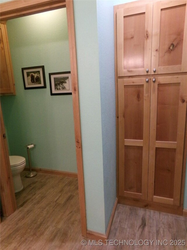 107349 S 4091st Rd, Checotah, OK 74426 - bathroom featuring toilet, wood finished floors, and baseboards