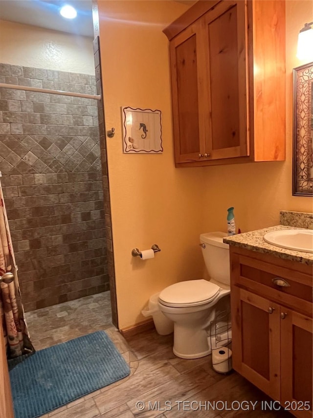 107349 S 4091st Rd, Checotah, OK 74426 - bathroom featuring toilet, wood finished floors, vanity, and a tile shower