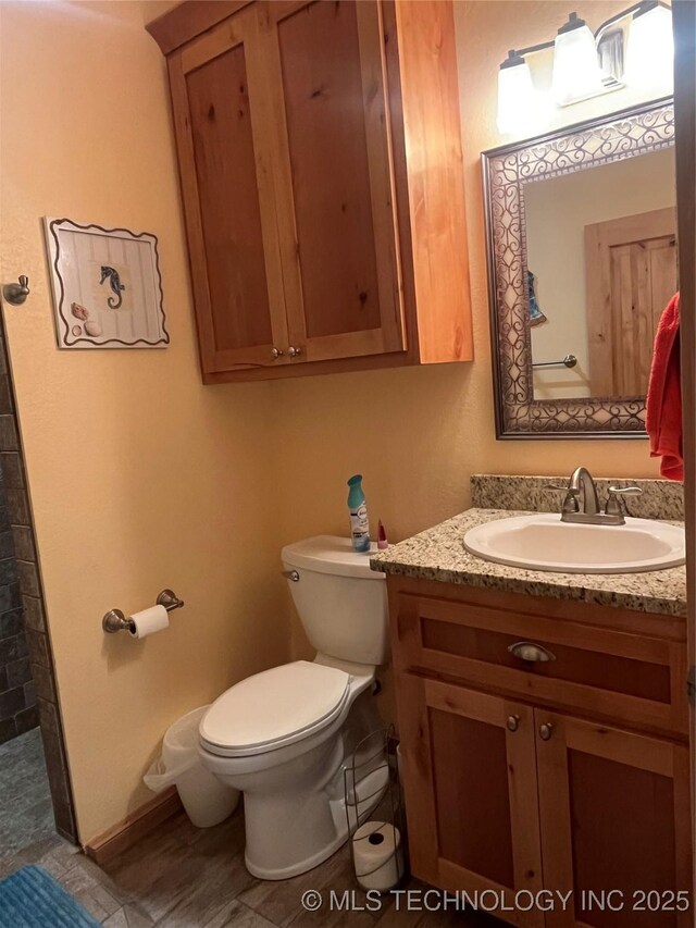 107349 S 4091st Rd, Checotah, OK 74426 - full bathroom featuring baseboards, toilet, vanity, and tiled shower