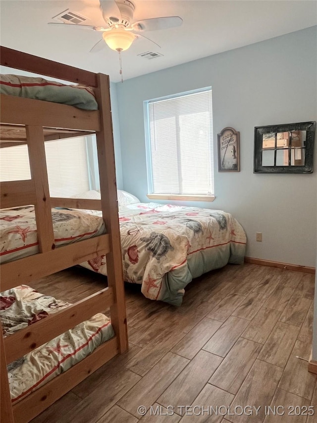 107349 S 4091st Rd, Checotah, OK 74426 - bedroom featuring wood finished floors, visible vents, baseboards, and ceiling fan