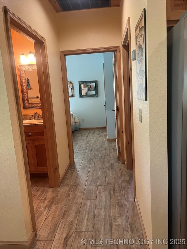 107349 S 4091st Rd, Checotah, OK 74426 - corridor with wood finished floors, visible vents, and a sink