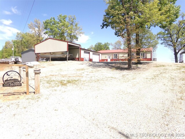 107349 S 4091st Rd, Checotah, OK 74426 - view of front facade featuring a detached garage and an outbuilding
