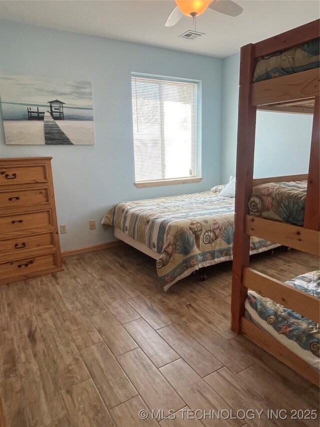107349 S 4091st Rd, Checotah, OK 74426 - bedroom with baseboards, a ceiling fan, wood finished floors, and visible vents