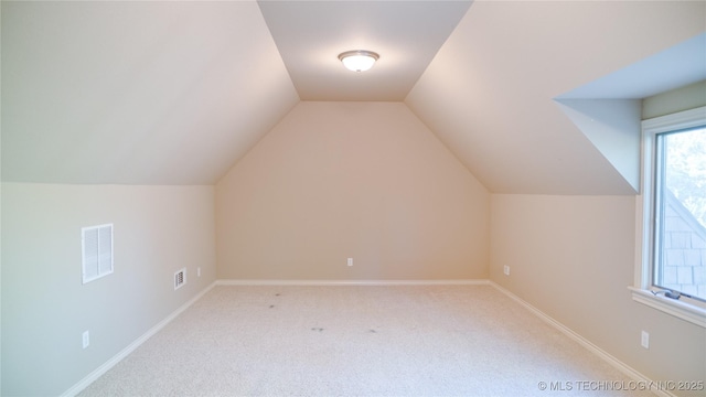 5132 E 85th St, Tulsa, OK 74137 - bonus room featuring visible vents, baseboards, vaulted ceiling, and carpet floors