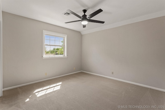 spare room featuring ceiling fan, carpet flooring, baseboards, and visible vents