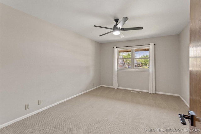 spare room featuring baseboards, visible vents, ceiling fan, and carpet floors