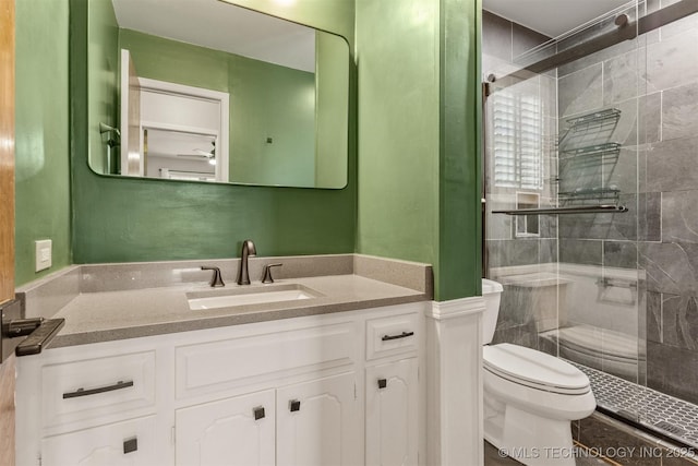 bathroom with vanity, toilet, and a shower stall