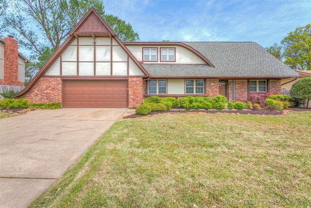 tudor house featuring a front lawn, concrete driveway, stucco siding, and brick siding