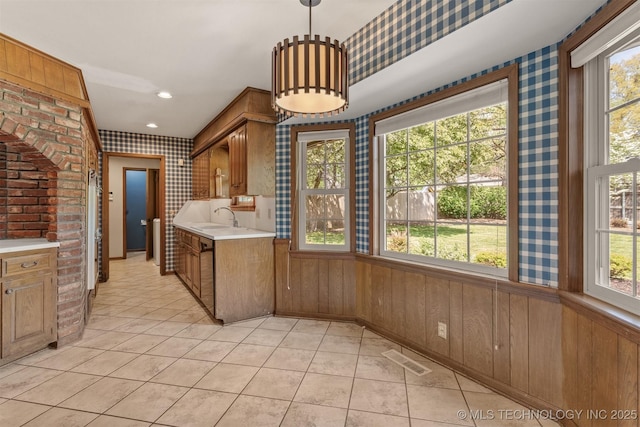 kitchen featuring a sink, wallpapered walls, visible vents, light countertops, and light tile patterned flooring