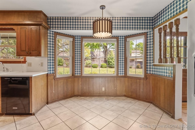 unfurnished dining area with wood walls, light tile patterned flooring, a wainscoted wall, and wallpapered walls