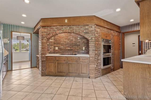 kitchen featuring light countertops, light tile patterned floors, stainless steel double oven, and recessed lighting