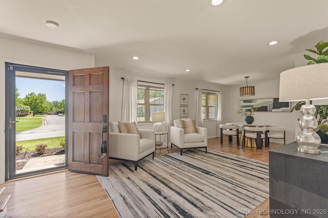 living room with light wood finished floors and recessed lighting