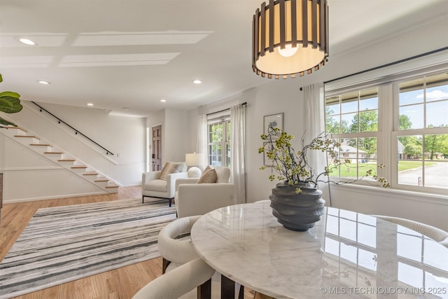 dining area with baseboards, stairway, recessed lighting, and wood finished floors