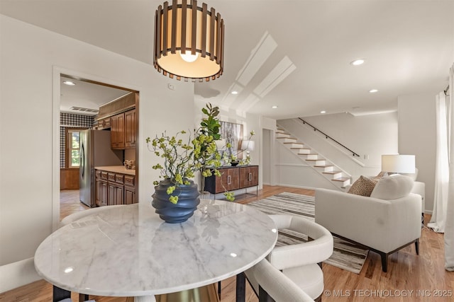 dining area with stairs, light wood-style flooring, and recessed lighting