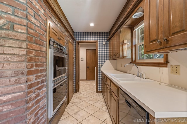 kitchen featuring a sink, black dishwasher, stainless steel double oven, light countertops, and light tile patterned floors