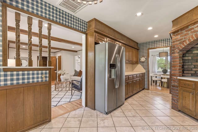 kitchen with light tile patterned floors, wallpapered walls, stainless steel fridge with ice dispenser, visible vents, and recessed lighting
