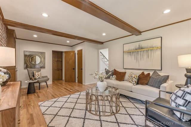living room featuring stairway, ornamental molding, wood finished floors, and beam ceiling