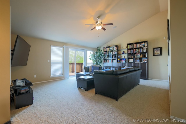 living room with lofted ceiling, a ceiling fan, baseboards, and light colored carpet