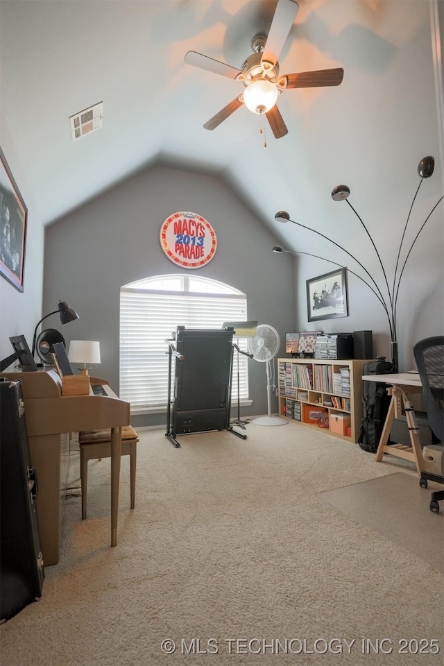 carpeted home office with ceiling fan, lofted ceiling, and visible vents