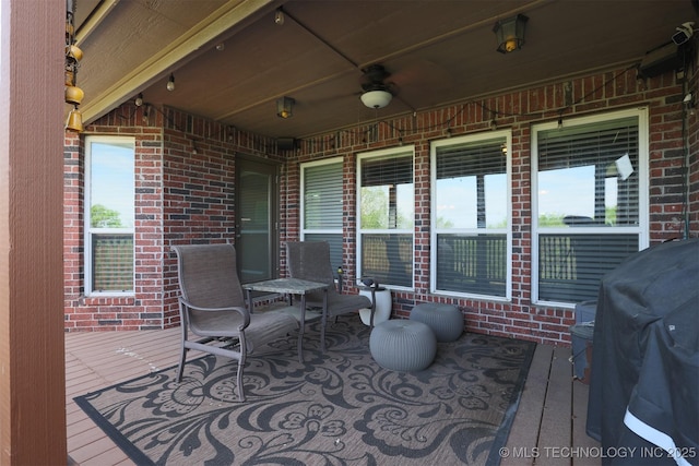 view of patio featuring a wooden deck, a ceiling fan, and area for grilling
