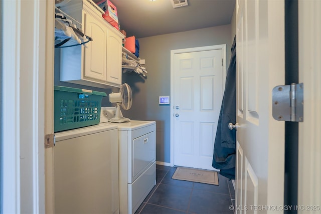 clothes washing area featuring cabinet space, washer and clothes dryer, dark tile patterned flooring, and visible vents