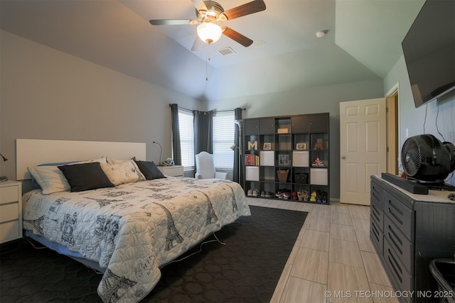 bedroom featuring lofted ceiling, visible vents, and ceiling fan