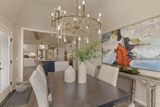 dining space with a towering ceiling and a chandelier