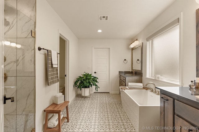 full bath featuring vanity, a soaking tub, a shower stall, tile patterned floors, and recessed lighting