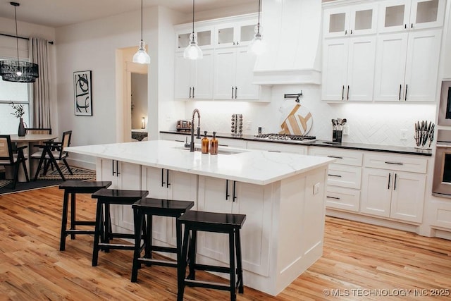 9520 N 144th Ave E, Owasso, OK 74055 - kitchen featuring premium range hood, backsplash, and light wood-type flooring