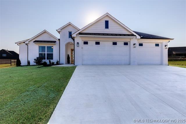 9520 N 144th Ave E, Owasso, OK 74055 - single story home with an attached garage, driveway, a standing seam roof, a front lawn, and metal roof
