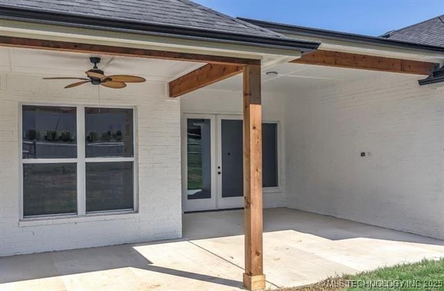 9520 N 144th Ave E, Owasso, OK 74055 - view of exterior entry with french doors, a patio, a ceiling fan, and roof with shingles