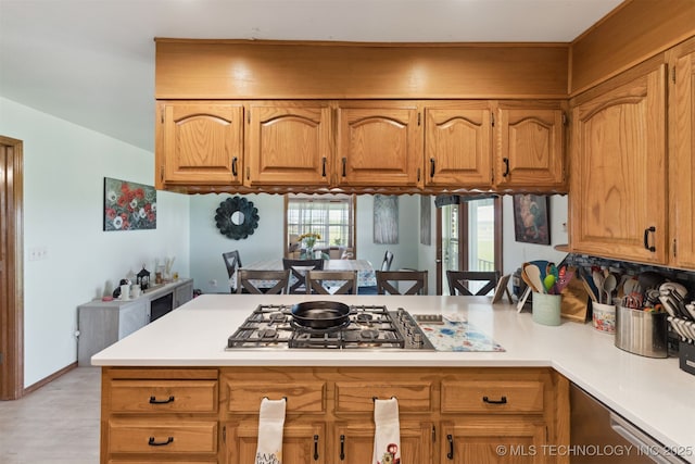 10495 S 426th Rd, Inola, OK 74036 - kitchen featuring a peninsula, stainless steel gas stovetop, light countertops, and brown cabinets