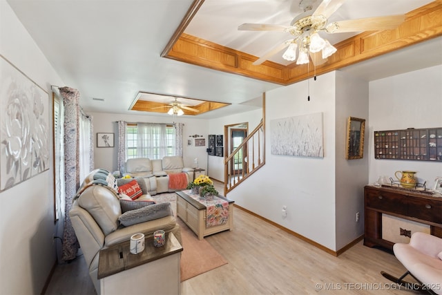 10495 S 426th Rd, Inola, OK 74036 - living room with ceiling fan, light wood-style floors, a raised ceiling, and stairs