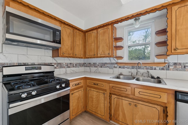 13973 S Hickory St, Glenpool, OK 74033 - kitchen featuring stainless steel appliances, light countertops, a sink, and brown cabinetry
