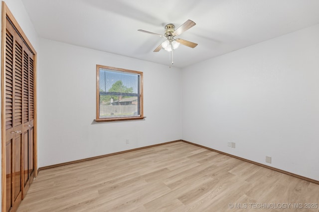 13973 S Hickory St, Glenpool, OK 74033 - unfurnished bedroom with light wood-type flooring, baseboards, a closet, and ceiling fan