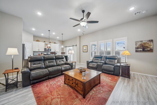 13010 E 125th Pl N, Collinsville, OK 74021 - living room featuring ceiling fan, recessed lighting, light wood-type flooring, and a barn door