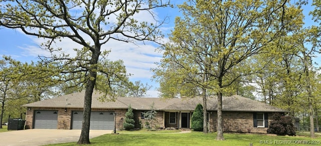 view of front of property with a garage, brick siding, a front yard, and concrete driveway