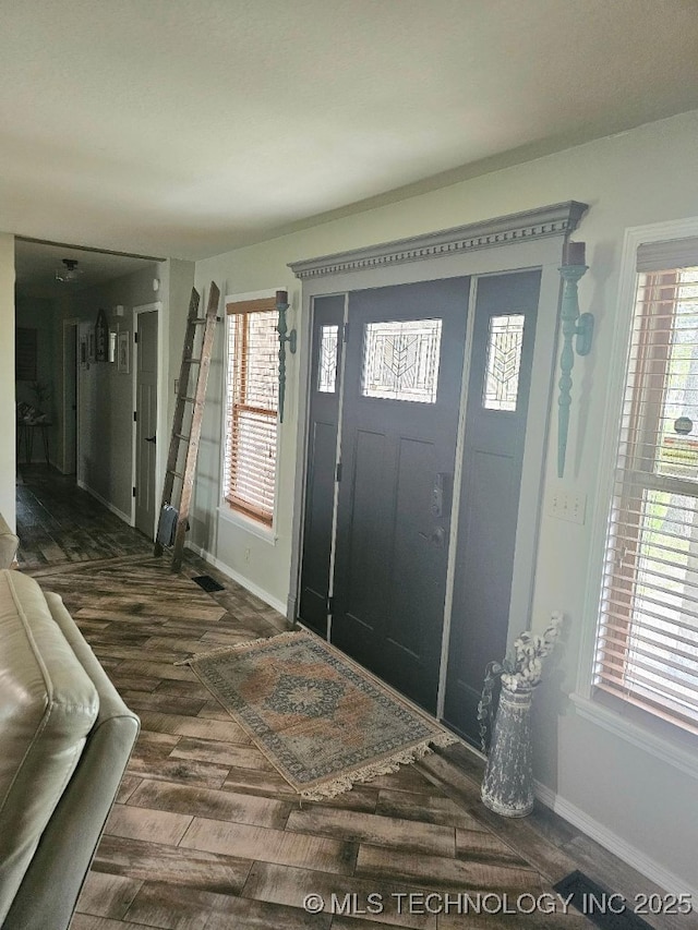 entryway with baseboards, wood finished floors, and a wealth of natural light