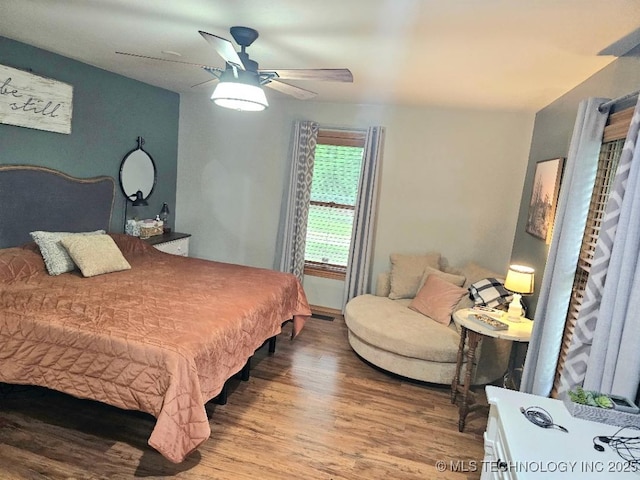 bedroom with ceiling fan and wood finished floors