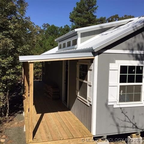 view of exterior entry featuring a deck