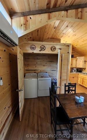 dining room with wood walls, dark wood-type flooring, and washing machine and dryer