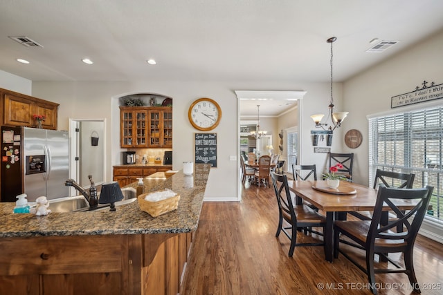 dining space featuring dark wood finished floors, a chandelier, visible vents, and recessed lighting