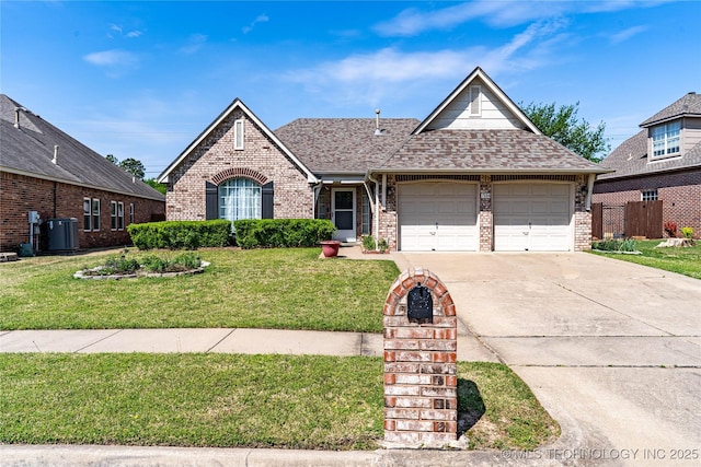 view of front of property featuring a front lawn, driveway, brick siding, a garage, and a shingled roof