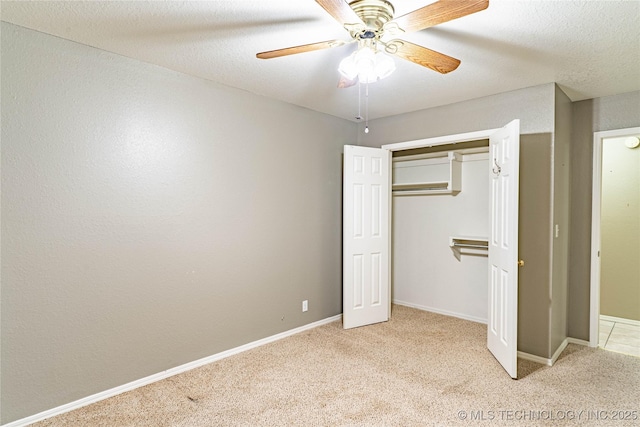 unfurnished bedroom featuring ceiling fan, light carpet, baseboards, and a closet