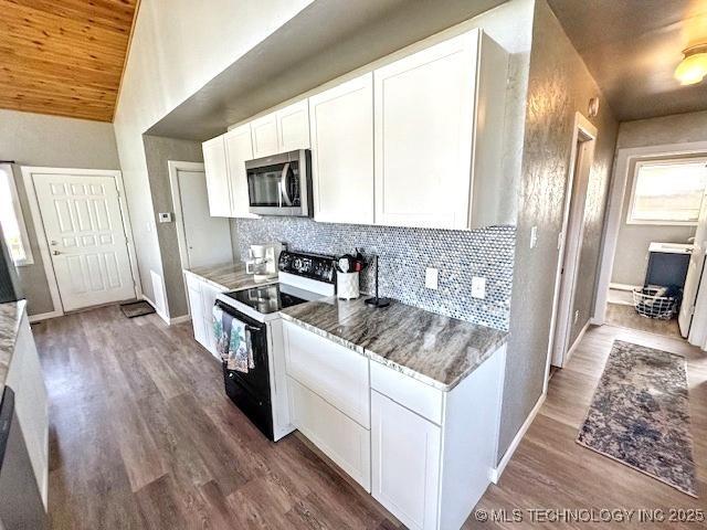 19690 W 892nd Rd, Park Hill, OK 74451 - kitchen featuring stainless steel microwave, electric stove, decorative backsplash, white cabinets, and wood finished floors